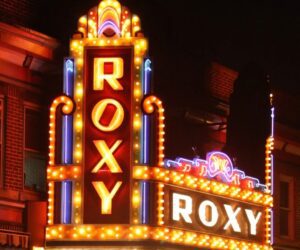 A close up of the roxy sign at night.